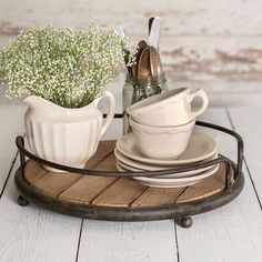 a tray with two cups and saucers on it