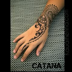 a woman's hand with a tattoo on it and the words catana written in arabic