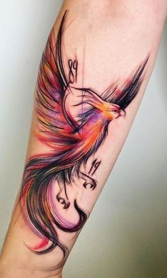 a colorful bird tattoo on the arm