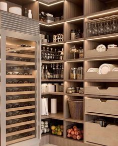 a kitchen pantry filled with lots of food and wine bottles in it's shelves