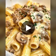 a bowl filled with pasta and mushrooms on top of a table