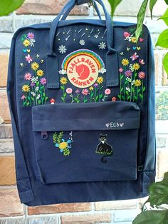 Welcome to our charming collection of hand-embroidered Fjallraven Kanken backpacks, meticulously crafted with love and precision. Elevate your style and stay organized on-the-go with these premium quality backpacks available in two convenient sizes:  - Medium (27x38x13cm)  - Large (32x42x13cm) + Key Features: - Hand-Embroidered Excellence: Each Fjallraven Kanken backpack is adorned with exquisite hand-embroidery, creating a unique and exclusive piece that sets you apart from the crowd. - Premium Quality Materials: Crafted from durable and eco-friendly materials, our Kanken backpacks ensure longevity and sustainability. They can withstand the rigors of daily use, making them ideal companions for all your adventures. - Versatile and Ideal for All Ages: Whether you're a student, a traveler, o Kanken Backpack Embroidery, Decorated Backpack, Embroidered Kanken, Backpack Embroidery, Flowers Hand Embroidery, Embroidered Backpack, Backpack Decoration, Cute Embroidery, Hand Embroidery Design