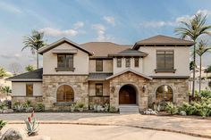 a large house with lots of windows and landscaping