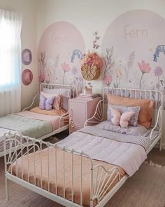 two twin beds in a bedroom with pink walls