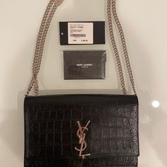 Ysl Saint Laurent Paris Kate Medium Shoulder Bag Monogramme Crocodile Embossed Print Leather Nero (Black) Silver Hardware Without Tassel Calfskin Leather 100% Authentic Saint Laurent -Includes Original Price Tag, Unopened Envelope Containing Authentication, Maintenance Booklet, Item Info Card, Brand Card, Etc. -I Purchased It From A Saint Laurent Store Similar Bag Currently Retails For $3,100 On Ysl Website Not Including Tax Material: Calf Leather Internal Details: Fabric Lining, Internal Slot P Ysl Tassel Bag, Saint Laurent Store, Brand Card, Kate Bags, Ysl Saint Laurent, Embossed Printing, Saint Laurent Paris, Tassel Bag, Saint Laurent Bag