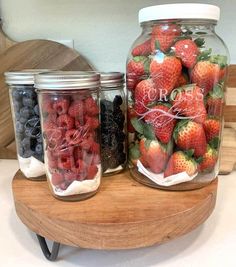 two jars filled with fresh strawberries next to each other on a wooden table and the words keep berries fresh for weeks