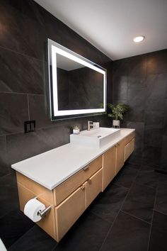 a bathroom with a large mirror above the sink