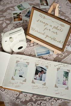 an open book with pictures on it next to a polaroid camera and other items