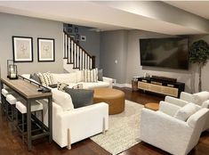 a living room filled with furniture and a flat screen tv mounted on the wall over a fireplace