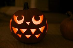 a carved pumpkin with glowing eyes on it