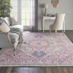 a living room filled with furniture and a rug