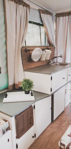 a kitchen area with sink, stove and cabinets in it's own houseboat