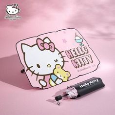 the hello kitty sticker is next to an empty lip balm tube on a pink background