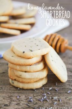 honey lavender shortbread cookies stacked on top of each other next to a plate full of them