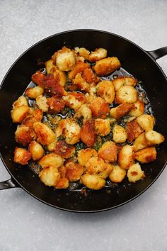 some food is cooking in a frying pan on the stove top and ready to be eaten