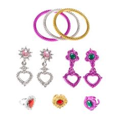 several pairs of earrings and rings on a white background