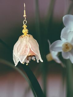 Beautiful handmade clear cold porcelain, and beads created an unique and one kind earrings. Gold tone hardware used to finish. It will look beautiful with any outfit in any occasion. Earring with theirs sparkles will highlight the sparkling of your eyes. Light weight, and unique they will bring you joy and brighten your image. Gold Flower-shaped Polymer Clay Earrings, Gold Whimsical Polymer Clay Earrings, Whimsical Gold Polymer Clay Earrings, Handmade Gold Flower Earrings In Polymer Clay, Handmade Gold Polymer Clay Flower Earrings, Handmade Polymer Clay Flower Earrings In Gold, Elegant Gold Flower Earrings Polymer Clay, Handmade Gold Flower Earrings With Czech Glass, Gold Flower-shaped Czech Glass Earrings