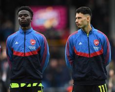 two soccer players standing next to each other