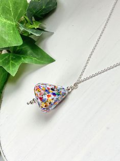 Unique, and special vintage Murano glass pendant necklace. This pyramid shaped opaque white glass with colorful speckles will be a delightful addition to your wardrobe and Murano glass collection. The pendant hangs on a Sterling silver adjustable chain. You simply slide the chain to your desired length to wear with any neckline from 14-21 inches. A wonderful gift for any occasion and arrives in a standard gift box. ✨ Authentic Murano Glass: Each pair of earrings showcases the unparalleled beauty of Murano glass, renowned for its vibrant colors and intricate patterns. See our other Venetian Murano glass jewelry in our designated section at this link: https://www.etsy.com/shop/ScarletMareStudio?ref=seller-platform-mcnav§ion_id=15159733 FOR GIFT GIVING: ** Satin gift pouch with note card and Multicolor Recycled Glass Necklace As Gift, Multicolor Recycled Glass Necklaces For Gifts, White Czech Glass Necklaces As Gift, Pendant Necklace Vintage, Murano Glass Jewelry, Colorful Necklace, Glass Pendant Necklace, Venetian Glass, Gift Pouch