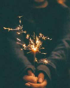 a person holding a sparkler in their hands