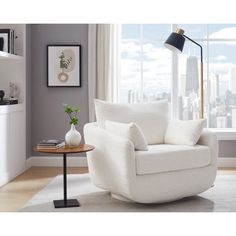 a living room with a white chair and table in front of a large window overlooking the city