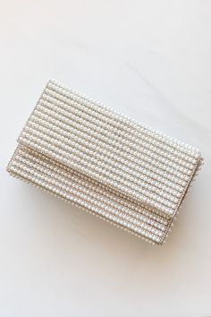 Look your best for that special moment with the Going To The Chapel Clutch! This stylish bridal bag is decked out with beautiful pearl and rhinestone accents and comes with an extra chain link strap so you can grab-and-go like nobody's business. Perfect for the bride-to-be or as a gift for that special someone, this clutch will make you say "I do" (to looking fabulous, that is). Pearl Clutch Purse, Banquet Outfits, Prom Clutch Bag, Venice Elopement, Banquet Outfit, Pearl Bags, Bride Purse, Bride Clutch, Going To The Chapel