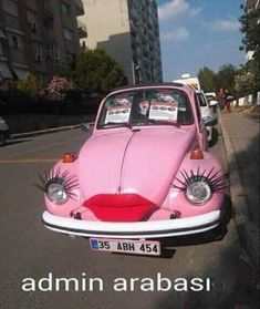 an old pink car with fake eyelashes on it