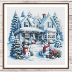 a cross stitch christmas scene with two snowmen in front of a house