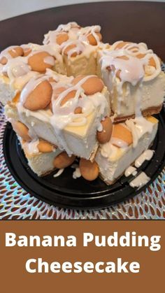 there is a cake with white frosting and nuts on the top, sitting on a black plate