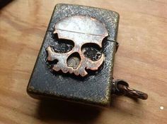 a lighter with a skull on it sitting on a table