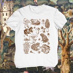 Frogs and Mushrooms t-shirt * Botanical Cottagecore Goblincore shirt * Vintage Aesthetic top * Dark Academia fashion * Frog Toadstool top  ALL SIZES ARE UNISEX (despite of it saying "Men's" in the size options)  *About Fern and Fly* Our designs are unique, created, edited or drawn by us and are all inspired by all things nature, magic, art and folklore! *Material* 100% cotton. Pre-shrunk for extra durability. Shoulder-to-shoulder taping. Quarter-turned to avoid crease down the center. *Print* On Goblincore Cotton Streetwear Tops, White Graphic Tee With Mushroom Design, Short Sleeve Tops With Mushroom Print For Streetwear, Mushroom Print Cotton Top For Streetwear, Cotton Mushroom Print Top For Streetwear, Cotton Top With Mushroom Print For Streetwear, Frogs And Mushrooms, Botanical Cottagecore, Goblincore Shirt