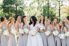 a group of bridesmaids standing in front of each other