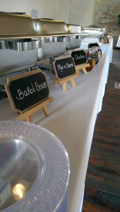 a buffet table set up with chalkboard signs