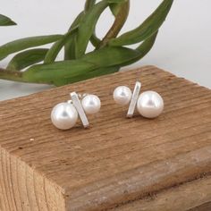 "Simple Two Pearl Earrings that can easily dress up any outfit for any occasion! Top Pearl - 6mm Bottom Pearl - 8mm Pearl Type - Shell Pearl Stud Earring Material - Solid Sterling Silver Stud Length - 12mm Stud Width - 4mm Stud Thickness - 2mm Post Length - 9.5mm (3/8\") Post Thickness - 20 gauge (0.81mm) Ear Back Type - Push On Ear Back Material - Sterling Silver Sold As a Pair Finish - Matte or Polished The Finish option in the listing pictures is the matte finish" Silver Minimalist Pearl Earrings For Anniversary, Minimalist Silver Pearl Earrings For Anniversary, Silver Minimalist Pearl Earrings, Minimalist Hypoallergenic Sterling Silver Pearl Earrings, Hypoallergenic Minimalist Sterling Silver Pearl Earrings, Minimalist Sterling Silver Pearl Earrings In Silver, Minimalist Silver Sterling Silver Pearl Earrings, Small Pearl Earrings, Large Pearl Earrings