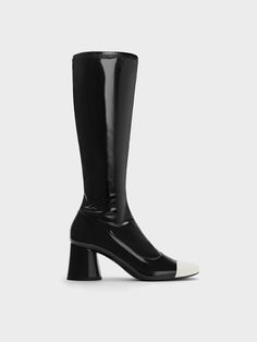 Neutrals can make a fashion statement too, and these Coco boots are a case in point. The glossy black finish is complemented by white toe-caps for a striking contrast, which adds visual interest to the minimalist knee-high silhouette. Set on sturdy cylindrical heels, they give a leg-lengthening effect while offering ease of wear. With side zips that make putting them on a breeze, these boots are a wearable statement to add to your wardrobe rotation. 25th Bday, Brand Collaboration, Faux Leather Heels, Size Chart For Kids, White Caps, Charles Keith, Boots Knee, Belt Size, Knee High Boots