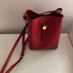 Lauren Ralph Lauren Drawstring Bucket Bag Color: Red Condition: Brand New Gift Shoulder Bag With Gold-tone Hardware, Red Rectangular Bucket Bag With Adjustable Strap, Elegant Bucket Bag With Adjustable Strap As Gift, Elegant Red Bucket Bag For Formal Occasions, Red Bucket Bag With Dust Bag For Travel, Red Elegant Bucket Bag For Daily Use, Elegant Red Bucket Bag For Everyday Use, Elegant Red Bucket Bag For Everyday, Elegant Red Everyday Bucket Bag