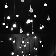 a room with many lights hanging from the ceiling