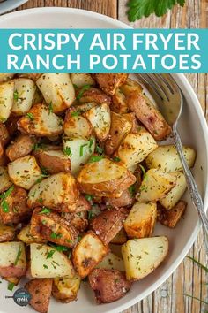 crispy air fryer ranch potatoes in a white bowl with a fork on the side