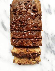 three slices of chocolate chip bread stacked on top of each other in front of a marble countertop