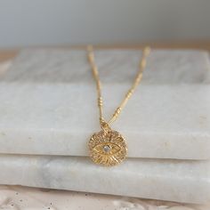 This stunning gold Evil Eye necklace is more than just an accessory--it's a powerful symbol of protection and good fortune. Crafted with an 18K gold-plated pendant and encrusted with sparkling cubic zirconia, this necklace is the perfect mix of elegance and meaning, designed to elevate your everyday style or serve as a thoughtful gift for someone special. 🌸 Details: Material: 18K Gold-Plated Brass Gemstones: Clear Cubic Zirconia Chain Length: 16 inch + 1-inch extender Pendant Size: 15 mm diameter 🌸 Why You'll Love It: This Evil Eye necklace offers both style and substance, combining timeless design with a protective symbol that's perfect for everyday wear. The gold-plated pendant and cubic zirconia accents catch the light beautifully, making this piece both eye-catching and versatile. 🌸 Spiritual Recycled Gold Round Pendant Jewelry, Dainty Delicate Chain Necklace For Good Luck, Spiritual Gold Birthstone Jewelry, Spiritual Gold-plated Tarnish-resistant Necklaces, Dainty Gold Plated Charm Necklace For Good Luck, Dainty Gold Charm Necklace For Good Luck, Spiritual Gold Plated Necklace As A Gift, Gold Birthstone Jewelry For Jewelry Making, Gold Recycled Amulet Jewelry