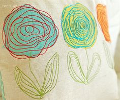 a close up of a pillow with flowers on it