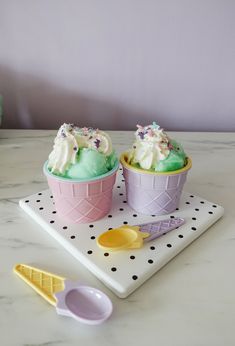 two cupcakes with green frosting and sprinkles in ice cream cones