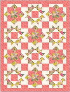 a pink and yellow quilt with many different designs on it's sides, including the center