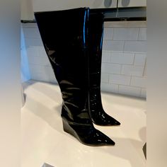 From The Asya Collection. Schutz’s Patent Leather Boots Feature A Pointed Toe And Side-Zip Closure. The Pair Is Elevated By A 109mm Wedge Heel. * 100% Patent Leather Upper * Pointed Toe * Side-Zip Closure * Synthetic Lining * 100% Leather Sole * Imported * True To Size * Wedge, 4.3” (109 Mm) * Shaft Height, 15.17” * Leg Opening, About 14.17” Party Wedge Boots With Reinforced Heel, Chic Fitted Wedge Boots With Round Toe, Casual Leather Wedge Boots For Party, Chic Round Toe Wedge Boots For Party, Chic Party Wedge Boots With Round Toe, Trendy Leather Wedge Boots With Pointed Toe, Leather Wedge Boots For Party, Black Wedge Boots With Reinforced Heel For Party, Formal Wedge Boots Medium Width