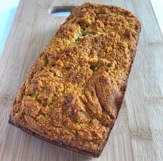 a loaf of bread sitting on top of a wooden cutting board