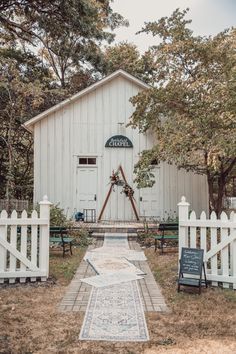 a white barn with a sign that says, the farm