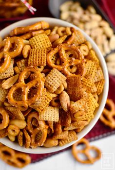 a bowl filled with cheetos and pretzels on top of a table