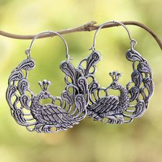 Among a garden of paisley motifs two peacocks add beauty to this pair of hoop earrings from Bali. Rupadana designs the earrings crafted of sterling silver. Ornate Handmade Hoop Earrings, Handmade Ornate Hoop Earrings, Oxidized Finish Chandbali Hoop Earrings, Bohemian Metal Earrings With Peacock Design, Intricate Chandbali Hoop Earrings, Silver Peacock Design Earrings, Ornate Hoop Earrings For Festivals, Chandbali Hoop Earrings With Oxidized Finish For Gift, Bohemian Jewelry With Peacock Design