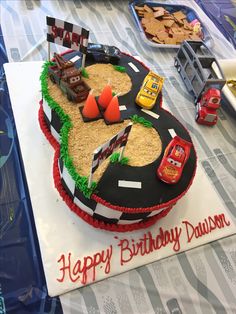 a birthday cake that is shaped like a race track