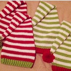 three knitted hats and mittens laying next to each other